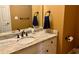 Bathroom with marble countertop, white cabinets, and neutral colored walls at 560 Hunt River Way, Suwanee, GA 30024