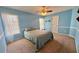Cozy bedroom with light blue walls, plush carpeting, and a comfortable-looking bed at 560 Hunt River Way, Suwanee, GA 30024