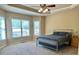 Comfortable bedroom with tray ceiling, ceiling fan and great natural light at 560 Hunt River Way, Suwanee, GA 30024