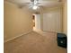 Neutral bedroom featuring plush carpet, ceiling fan and a double closet at 560 Hunt River Way, Suwanee, GA 30024