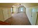 Spacious bonus room with neutral walls, plush carpet, and great natural light at 560 Hunt River Way, Suwanee, GA 30024