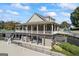 Two-story clubhouse featuring a wrap-around porch and outdoor seating area at 560 Hunt River Way, Suwanee, GA 30024