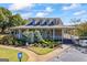 Charming clubhouse with covered porch, landscaped garden, and paved path at 560 Hunt River Way, Suwanee, GA 30024
