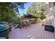 Spacious outdoor wooden deck featuring a grill, pergola and comfortable seating at 560 Hunt River Way, Suwanee, GA 30024