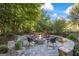 Outdoor stone fire pit with seating, perfect for gathering and enjoying the backyard at 560 Hunt River Way, Suwanee, GA 30024