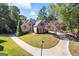 Expansive front yard featuring a circular driveway and lush greenery, highlighting the home's curb appeal at 560 Hunt River Way, Suwanee, GA 30024
