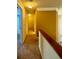 Upstairs hallway with carpet, neutral walls, and white trim at 560 Hunt River Way, Suwanee, GA 30024
