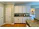 Kitchen with white cabinets, granite countertops, and stainless steel appliances at 560 Hunt River Way, Suwanee, GA 30024