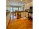 Well-lit kitchen with granite countertops, stainless steel appliances, and hardwood floors at 560 Hunt River Way, Suwanee, GA 30024