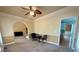 Open-concept living room with carpet flooring, arched doorway and natural light at 560 Hunt River Way, Suwanee, GA 30024