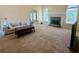 Cozy living room featuring fireplace, large windows, and comfortable seating at 560 Hunt River Way, Suwanee, GA 30024