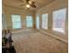 Spacious living room with large windows and a ceiling fan at 560 Hunt River Way, Suwanee, GA 30024