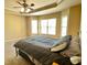 Comfortable main bedroom with tray ceiling and plenty of natural light at 560 Hunt River Way, Suwanee, GA 30024