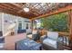 Relaxing pergola view, with lounge chairs, ceiling fan, and adjacent outdoor living space at 560 Hunt River Way, Suwanee, GA 30024