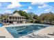 Spacious pool and clubhouse with a large deck and shaded seating area at 560 Hunt River Way, Suwanee, GA 30024