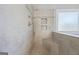 Modern shower with neutral tiling, built in shower seat, and decorative shower fixtures at 560 Hunt River Way, Suwanee, GA 30024