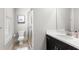 A clean, bright bathroom featuring a glass-enclosed shower, toilet, vanity, and modern fixtures at 914 Martin Nw St, Atlanta, GA 30318