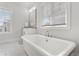 Bright bathroom featuring a freestanding tub and a large window at 914 Martin Nw St, Atlanta, GA 30318