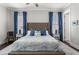 Bedroom featuring a tufted headboard, blue bedding, and matching blue curtains for a cozy and stylish space at 914 Martin Nw St, Atlanta, GA 30318