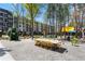 Park-like common area with picnic tables and green dog statue surrounded by apartments at 914 Martin Nw St, Atlanta, GA 30318