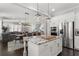 Open-concept kitchen with stainless steel appliances, a granite island, and seamless flow to living and dining areas at 914 Martin Nw St, Atlanta, GA 30318