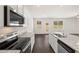 Modern kitchen featuring stainless steel appliances, white cabinets, and granite countertops at 12105 Conrad Cir, Hampton, GA 30228