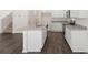 Kitchen with island, stainless appliances, granite countertops, and dark wood floors at 12105 Conrad Cir, Hampton, GA 30228