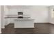 Modern kitchen boasts white cabinets, stainless steel appliances, and a granite-topped island, perfect for Gathering gatherings at 12105 Conrad Cir, Hampton, GA 30228