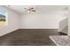 Bright living room with large windows, wood-look floors, and a view to the stairs provides a cozy and airy atmosphere at 12105 Conrad Cir, Hampton, GA 30228