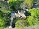 Aerial shot of the estate, displaying a long driveway and verdant trees in a quiet neighborhood at 2025 Golden Ridge Cir, Cumming, GA 30040
