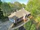 Aerial view of the brick home with a spacious driveway, attached garage, and manicured lawn at 2025 Golden Ridge Cir, Cumming, GA 30040