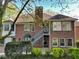 Elegant brick home with a staircase leading to upper level and well-manicured landscaping at 2025 Golden Ridge Cir, Cumming, GA 30040
