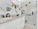 Modern bathroom featuring double vanity sinks, stylish light fixtures, and a glass-enclosed shower at 2025 Golden Ridge Cir, Cumming, GA 30040