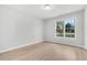 Minimalist bedroom with natural light, window view, and neutral walls at 2025 Golden Ridge Cir, Cumming, GA 30040