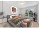 Comfortable bedroom with a large window, neutral color palette, and stylish decor at 2025 Golden Ridge Cir, Cumming, GA 30040