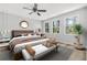 Well-lit bedroom with a ceiling fan, large windows, and a decorative bed at 2025 Golden Ridge Cir, Cumming, GA 30040