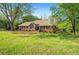 Charming brick home with a lush green lawn and mature trees, offering a welcoming curb appeal at 2025 Golden Ridge Cir, Cumming, GA 30040