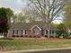 Attractive brick home featuring well-maintained landscaping and a neatly manicured front lawn at 2025 Golden Ridge Cir, Cumming, GA 30040