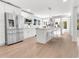 Modern kitchen with stainless steel appliances, white cabinets, and a stylish island with seating at 2025 Golden Ridge Cir, Cumming, GA 30040