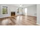 Bright living room featuring a fireplace, large windows, and wood flooring at 2025 Golden Ridge Cir, Cumming, GA 30040