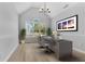Well-lit home office featuring a modern desk, vaulted ceilings, and a large window with a view at 2025 Golden Ridge Cir, Cumming, GA 30040