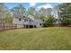 Spacious backyard with lush lawn, wooden fence, and a multi-level deck area at 2775 Whippoorwill Cir, Duluth, GA 30097