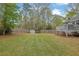 Expansive backyard features a grassy area, wooden fence, and a storage shed at 2775 Whippoorwill Cir, Duluth, GA 30097