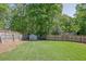 Fenced backyard with lush lawn and storage shed provides a private outdoor space at 2775 Whippoorwill Cir, Duluth, GA 30097
