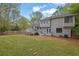 Large backyard with a well-maintained lawn, wooden fence, and a two-story home at 2775 Whippoorwill Cir, Duluth, GA 30097