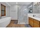 Bright bathroom featuring a soaking tub, a glass shower, and a stylish vanity at 2775 Whippoorwill Cir, Duluth, GA 30097