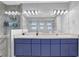 Bright bathroom with dual sinks, blue vanity, modern lighting, and a spacious, glass-enclosed shower at 2775 Whippoorwill Cir, Duluth, GA 30097