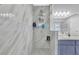 Modern walk-in shower with marble tiling, dual shower heads, and glass door at 2775 Whippoorwill Cir, Duluth, GA 30097