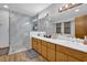 Bright bathroom with dual sinks, spacious shower, and elegant wood-grain cabinets at 2775 Whippoorwill Cir, Duluth, GA 30097