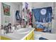 Eclectic bathroom featuring bright yellow vanity and a shower with moon-themed curtain at 2775 Whippoorwill Cir, Duluth, GA 30097